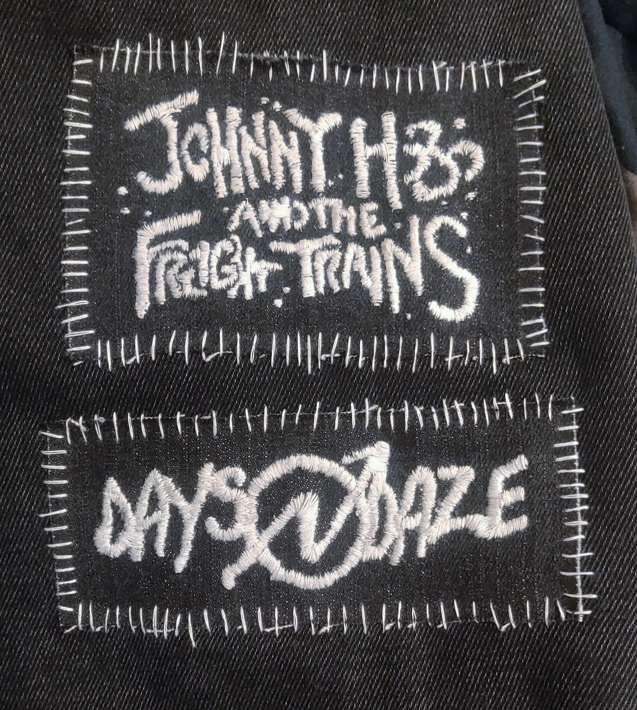 Two patches that show the band logos of Johnny Hobo and the Freight Trains and Days n' Daze.